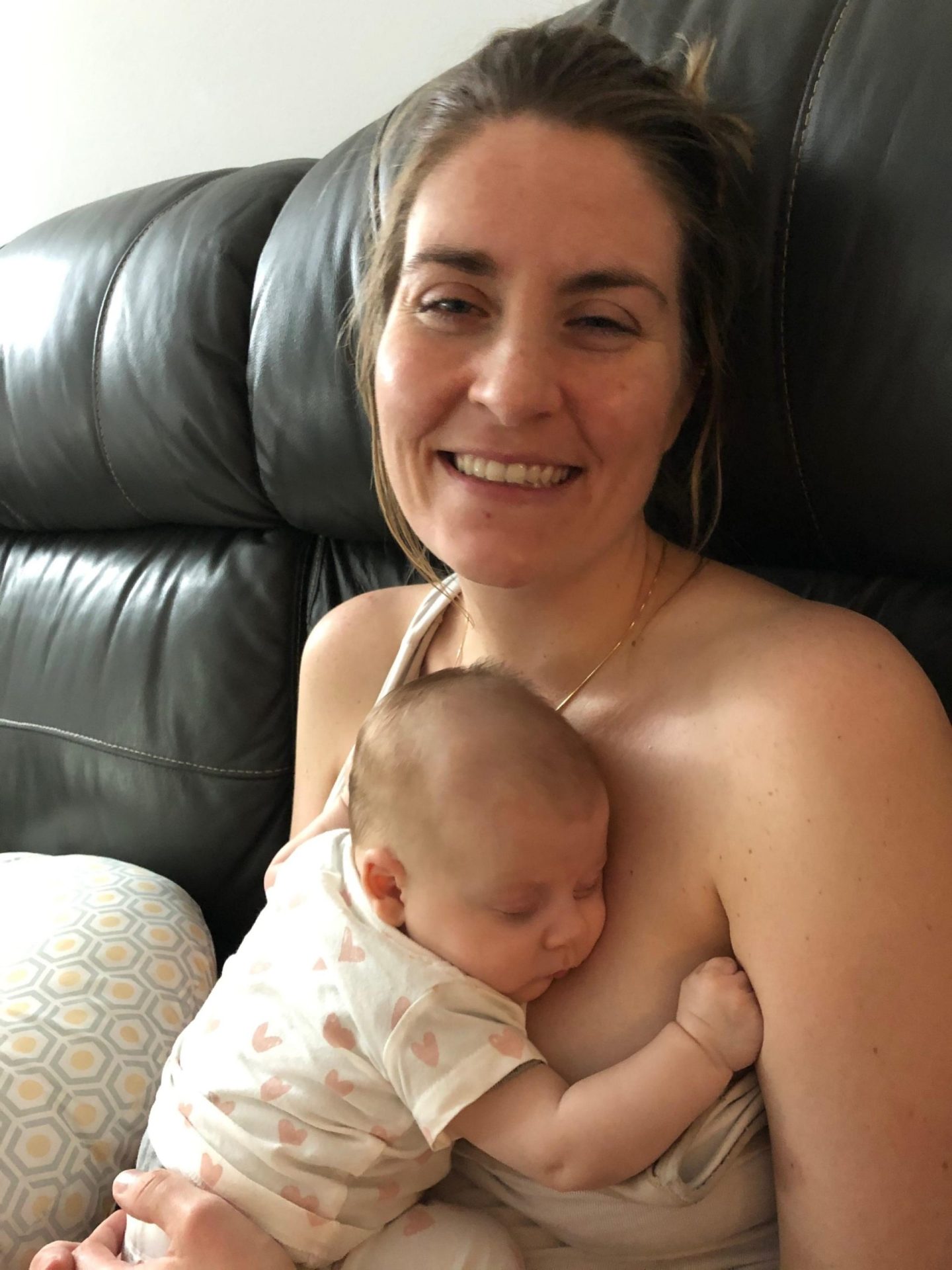 michelle holds her baby and smiles