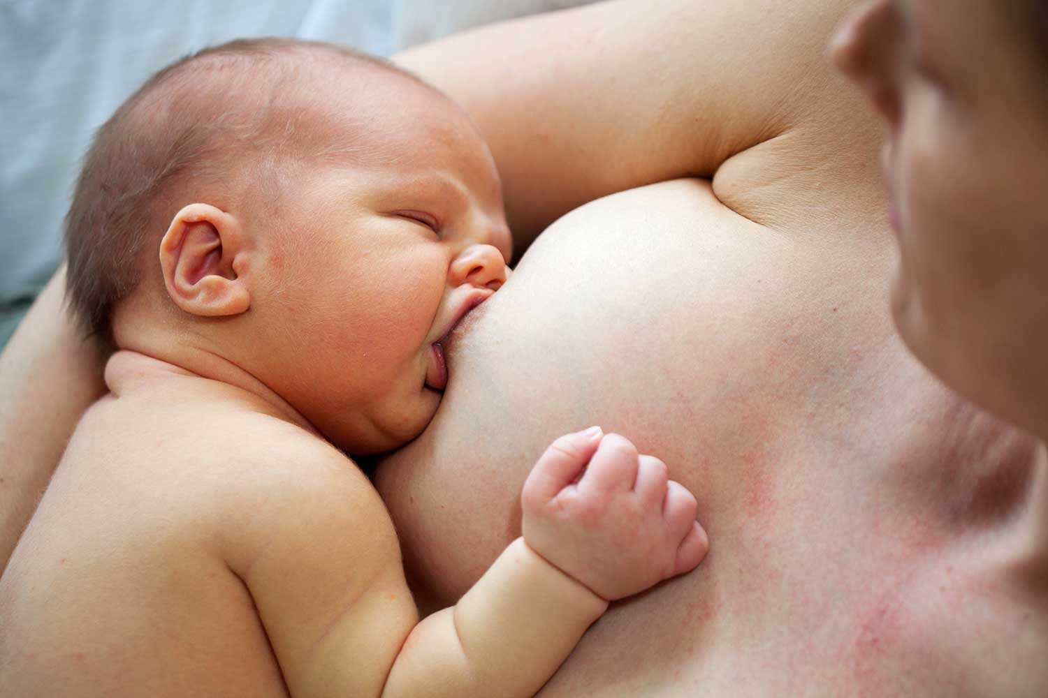 woman nurses her baby