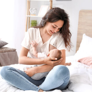 postpartum mom holding newborn at home